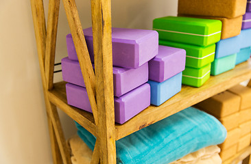 Image showing close up of rack with yoga foam blocks and plaids