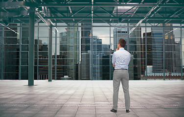 Image showing businessman from back over city construction