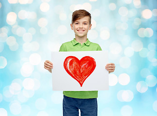 Image showing happy boy holding drawing or picture of red heart