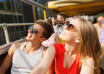 Image showing happy teenage couple traveling by tour bus