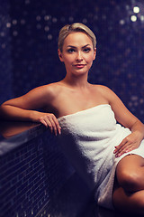 Image showing beautiful young woman sitting in bath towel