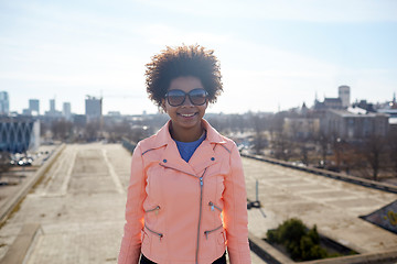 Image showing happy african american woman in shades on street