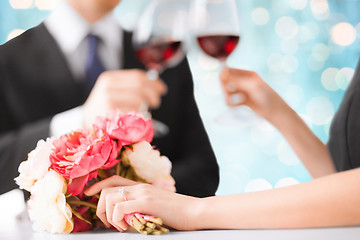 Image showing happy engaged couple with flowers and wine glasses