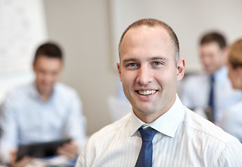 Image showing group of smiling businesspeople meeting in office