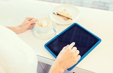 Image showing close up of woman with tablet pc drinking coffee