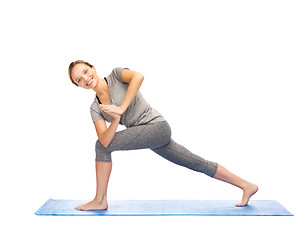 Image showing woman making yoga low angle lunge pose on mat