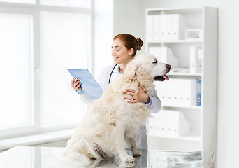 Image showing happy doctor with retriever dog at vet clinic