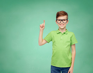 Image showing happy boy in eyeglasses pointing finger up