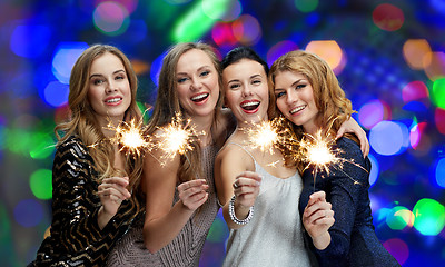 Image showing happy young women with sparklers over lights