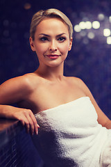 Image showing beautiful young woman sitting in bath towel