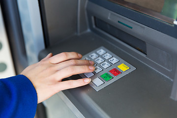 Image showing close up of hand entering pin code at cash machine