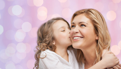 Image showing happy little girl hugging and kissing her mother