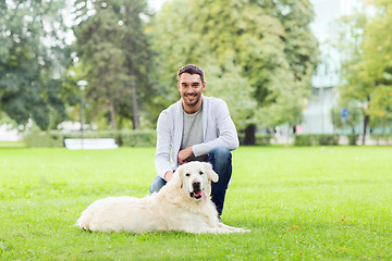Image showing happy man with labrador dog walking in city