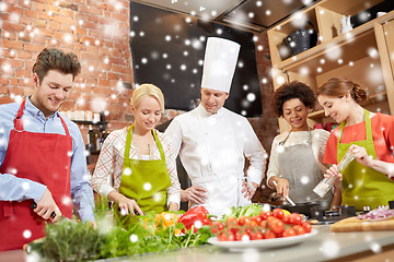 Image showing happy friends and chef cook cooking in kitchen