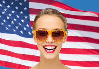 Image showing happy young woman in sunglasses over american flag