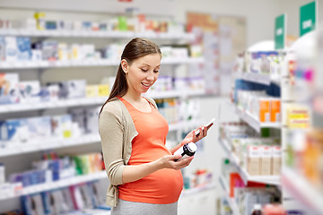 Image showing happy pregnant woman with smartphone at pharmacy