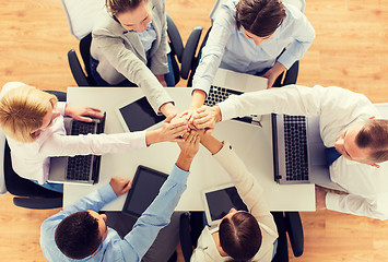 Image showing close up of business team with hands on top