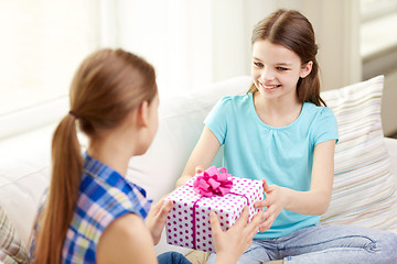 Image showing happy little girls with birthday present at home