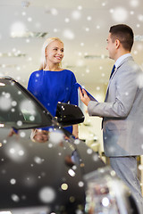 Image showing happy woman with car dealer in auto show or salon