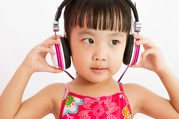 Image showing Chinese little girl on headphones