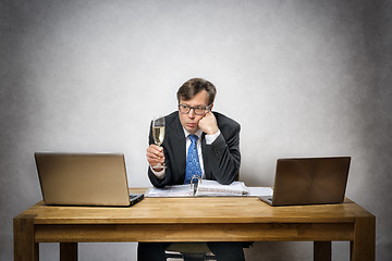 Image showing Lonely business man with champagne glass