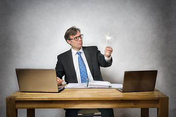 Image showing business man with sparkler