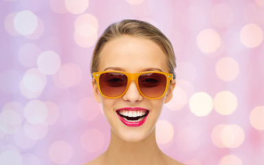 Image showing happy young woman in sunglasses with pink lipstick