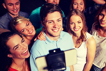 Image showing friends with smartphone taking selfie in club