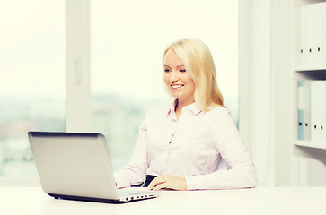 Image showing smiling businesswoman or student with laptop