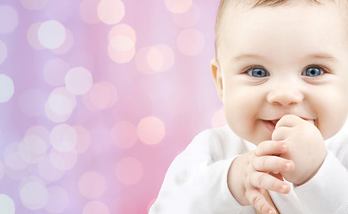 Image showing happy baby over pink lights background