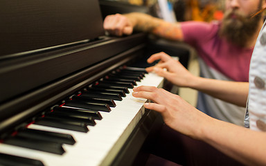 Image showing close up of woman hands playing piano