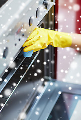 Image showing close up of woman cleaning oven at home kitchen