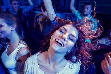 Image showing smiling friends dancing in club