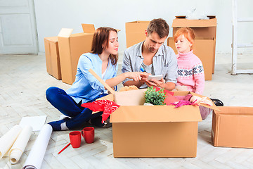 Image showing The happy family  during repair and relocation