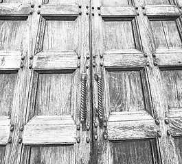 Image showing abstract texture of a brown antique wooden old door in italy   e