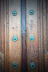 Image showing in london antique brown door  rusty  brass nail and light