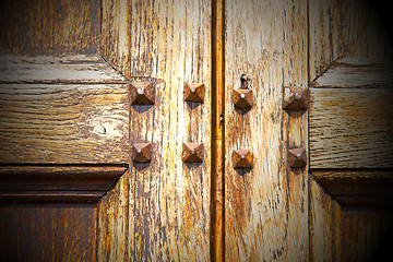 Image showing abstract texture of a brown antique wooden old door in italy   e