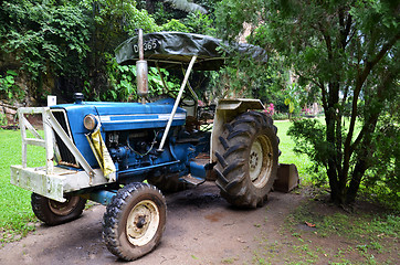 Image showing Blue tractor in the garden