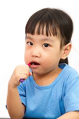 Image showing Chinese little girl brushing teeth