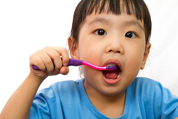 Image showing Chinese little girl brushing teeth