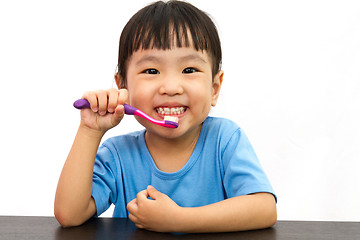 Image showing Chinese little girl brushing teeth