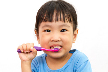 Image showing Chinese little girl brushing teeth