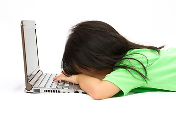 Image showing Chinese little girl sleep in front of a laptop