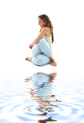 Image showing half lord of the fishes pose on white sand