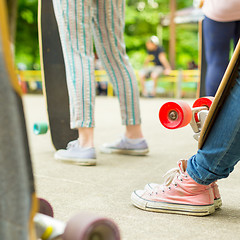 Image showing Teenage girl practicing riding long board.