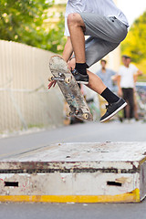 Image showing Boys skateboarding on street. Urban life.