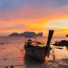 Image showing Traditional wooden longtail boat on beach in sunset, Thailand.