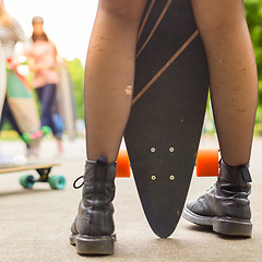 Image showing Teenage girl urban long board riding.