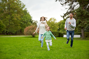 Image showing happy family walking in summer park