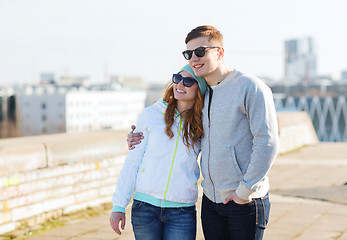 Image showing happy teenage couple walking in city